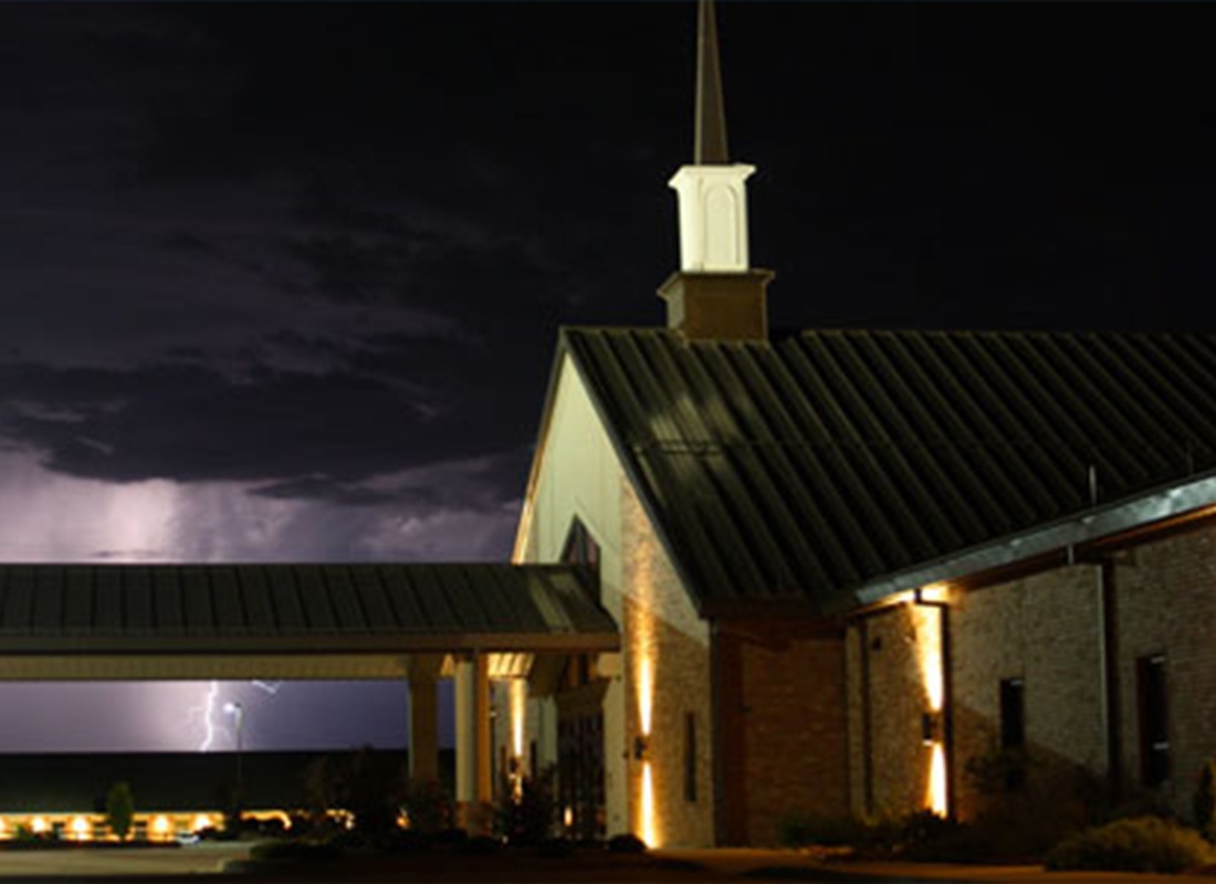 Insurance by Industry - A Shot of a Modern Church at Night With a Flash of LIghting in the Background